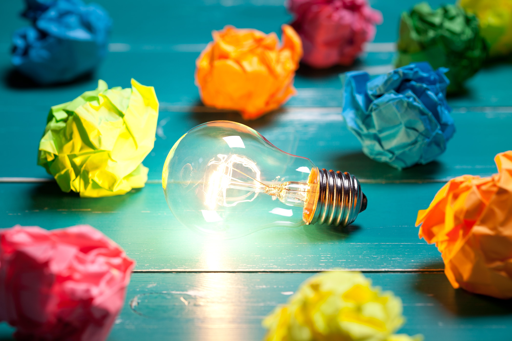 Incandescent bulb and colourful notes